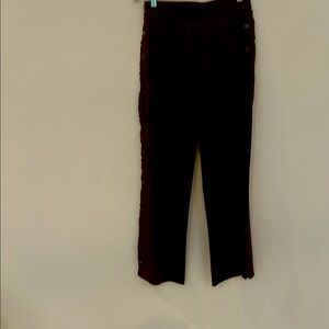 Tory Burch pants with decorative ruffles and buttons.